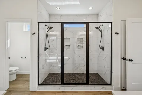 a view of a hallway with wooden floor and entryway