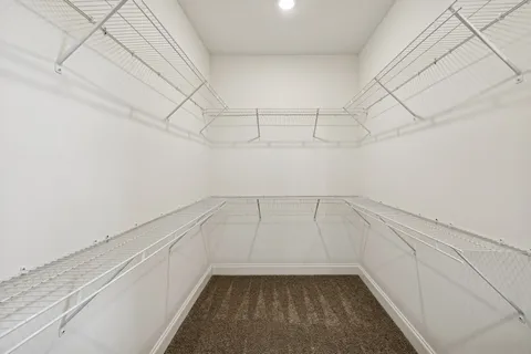 a view of a chandelier fan and hardwood floor