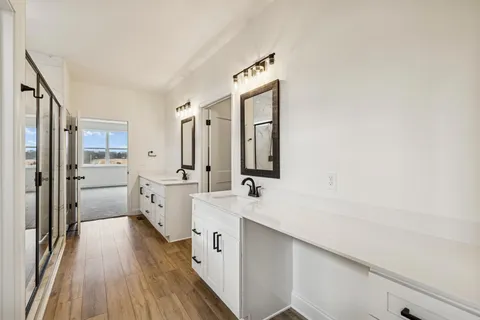 an empty room with ceiling fan and windows