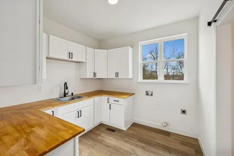 a bathroom with a granite countertop double vanity sink and a mirror