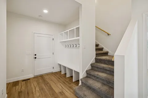 a living room with furniture potted plant and a flat screen tv