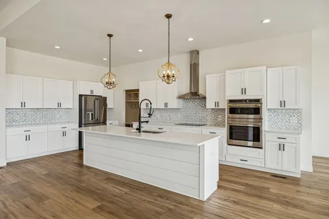 a view of wooden floor and windows in a room