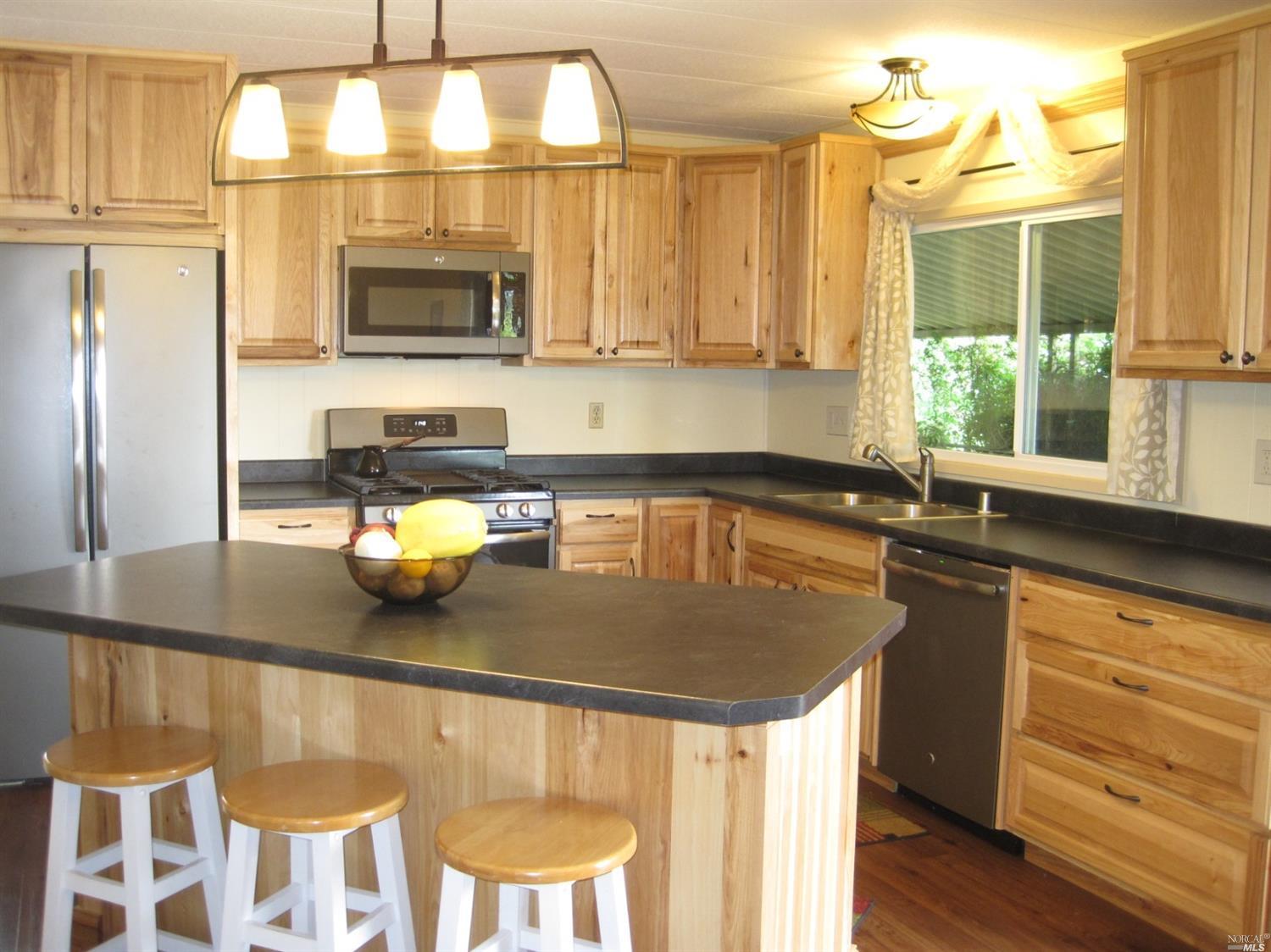 75 Yosemite Road, Unit 75 San Rafael, CA 94903 - Photo 1 of 1 a kitchen with a sink a stove and a refrigerator