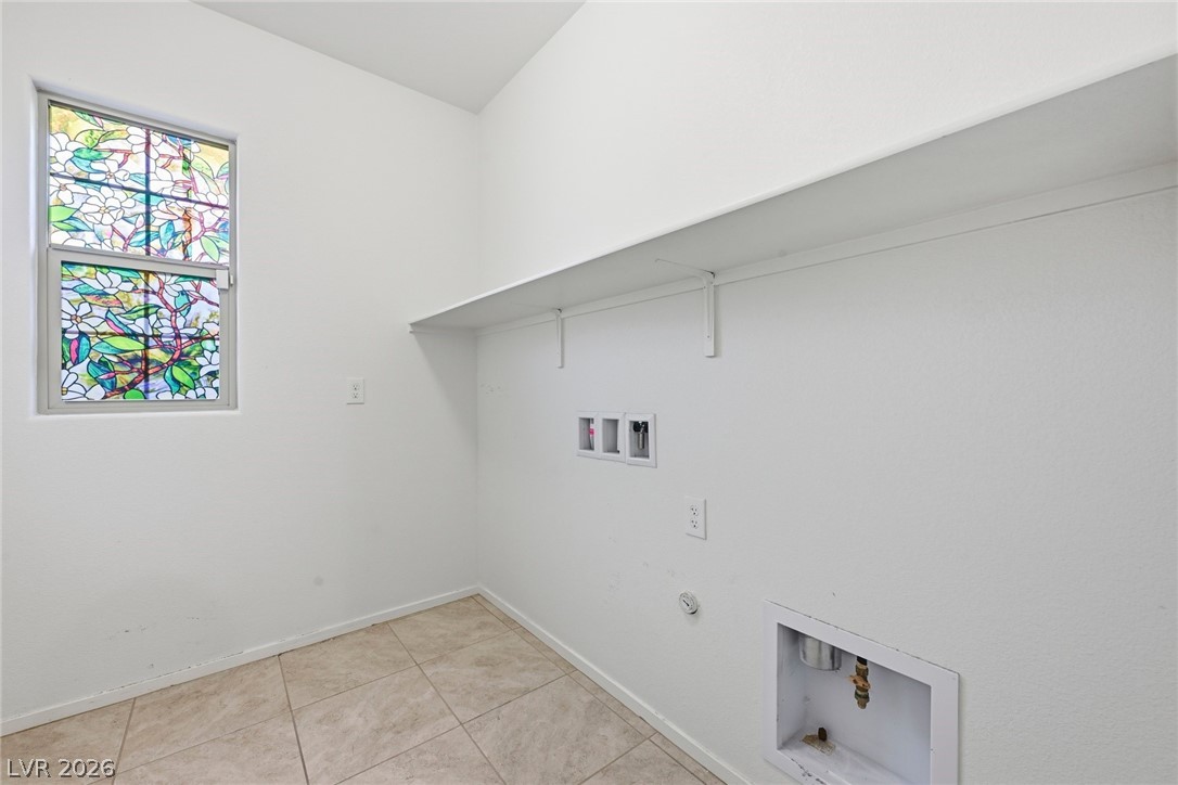 250 Dedication Avenue Henderson, NV 89011 - Photo 19 of 67 Laundry area with hookup for a gas dryer, hookup for a washing machine, and light tile patterned flooring