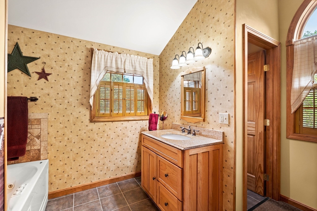 4 Alpha Road Groveland, MA 01834 - Photo 27 of 41 a bathroom with a sink a mirror and a bathtub