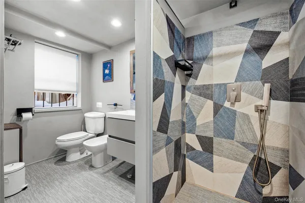 a bathroom with a toilet sink and a shower