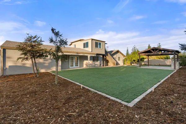 a front view of a house with a garden and yard