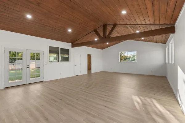 an empty room with a empty space and windows
