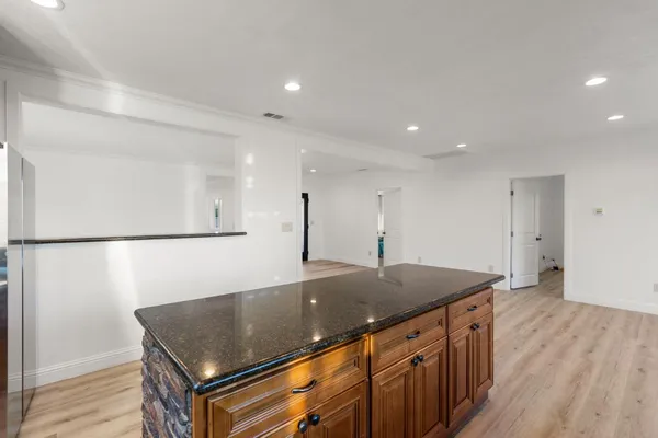 a view of a kitchen with a sink and wooden floor
