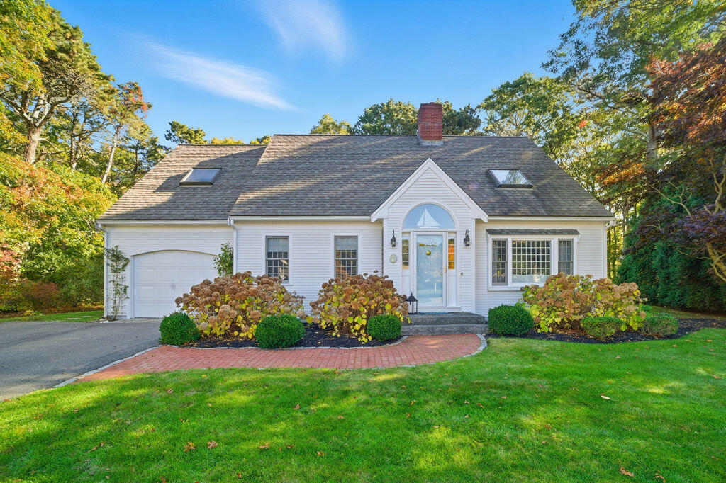 42 Eventide Lane Hyannis, MA 02601 - Photo 11 of 39 a front view of a house with a garden and plants