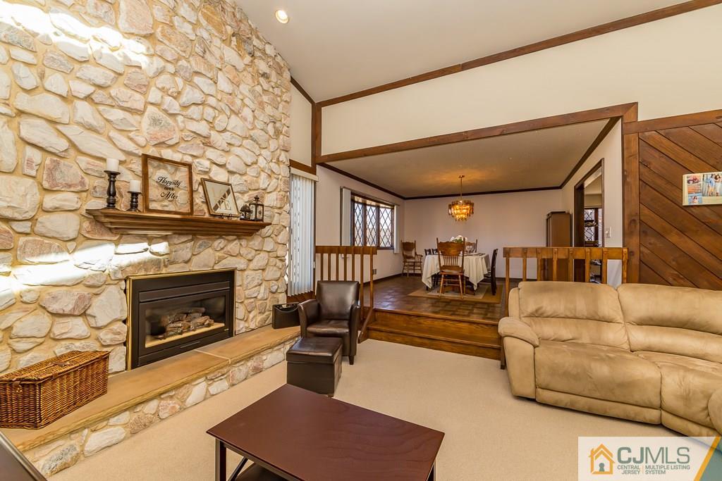 53 Rector Avenue Woodbridge, NJ 07095 - Photo 12 of 25 a living room with furniture fireplace and wooden floor