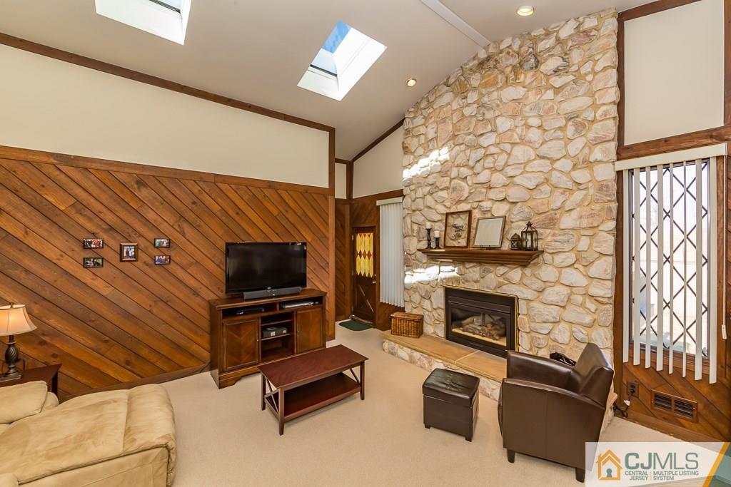 53 Rector Avenue Woodbridge, NJ 07095 - Photo 14 of 25 a living room with furniture flat screen tv and a fireplace