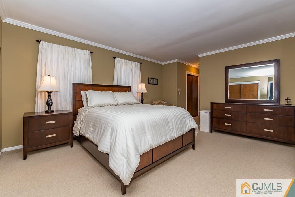 53 Rector Avenue Woodbridge, NJ 07095 - Photo 15 of 25 a bedroom with a bed and a tv on dresser