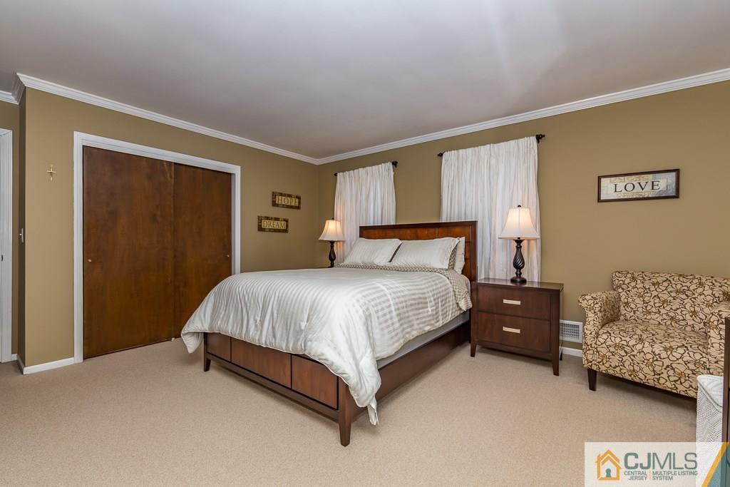 53 Rector Avenue Woodbridge, NJ 07095 - Photo 16 of 25 a bedroom with a bed and a night stand