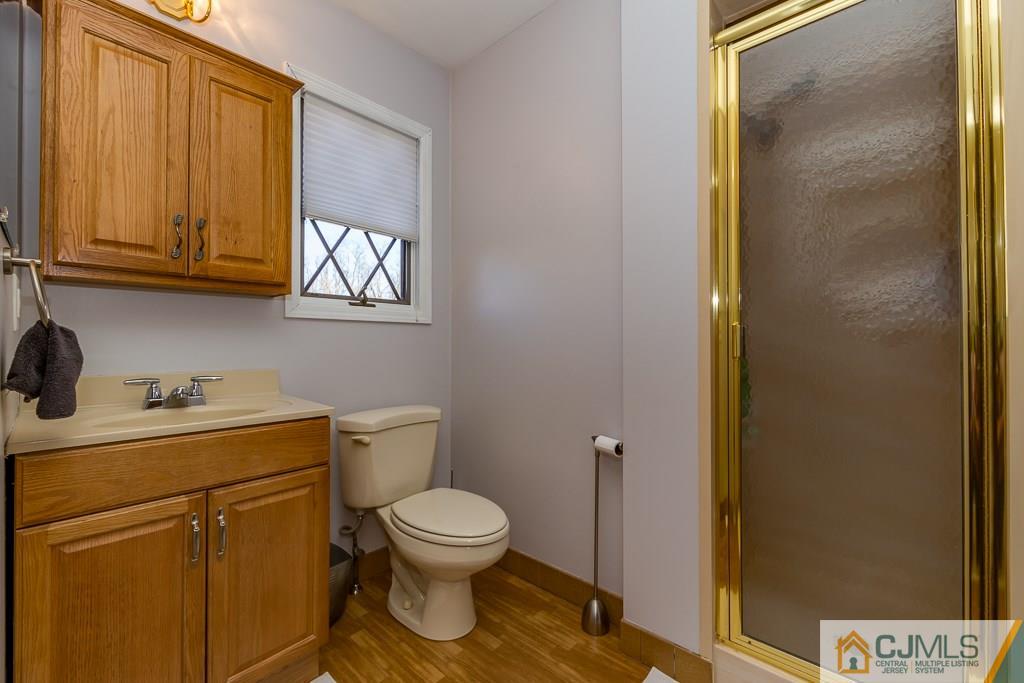 53 Rector Avenue Woodbridge, NJ 07095 - Photo 17 of 25 a bathroom with a toilet sink and mirror