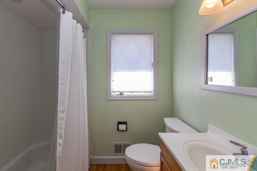 53 Rector Avenue Woodbridge, NJ 07095 - Photo 19 of 25 a white toilet sitting next to a bathroom sink