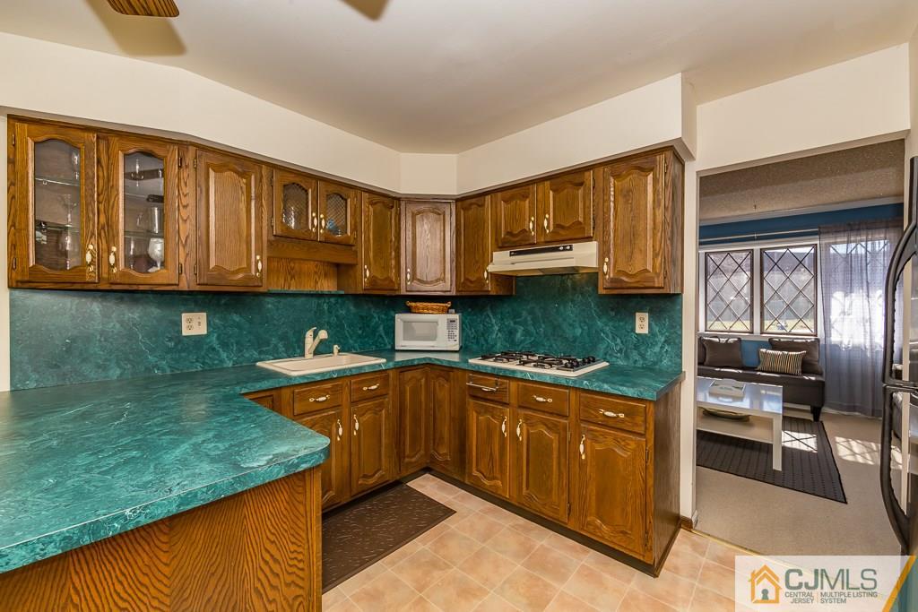 53 Rector Avenue Woodbridge, NJ 07095 - Photo 5 of 25 a kitchen with stainless steel appliances granite countertop a sink and cabinets