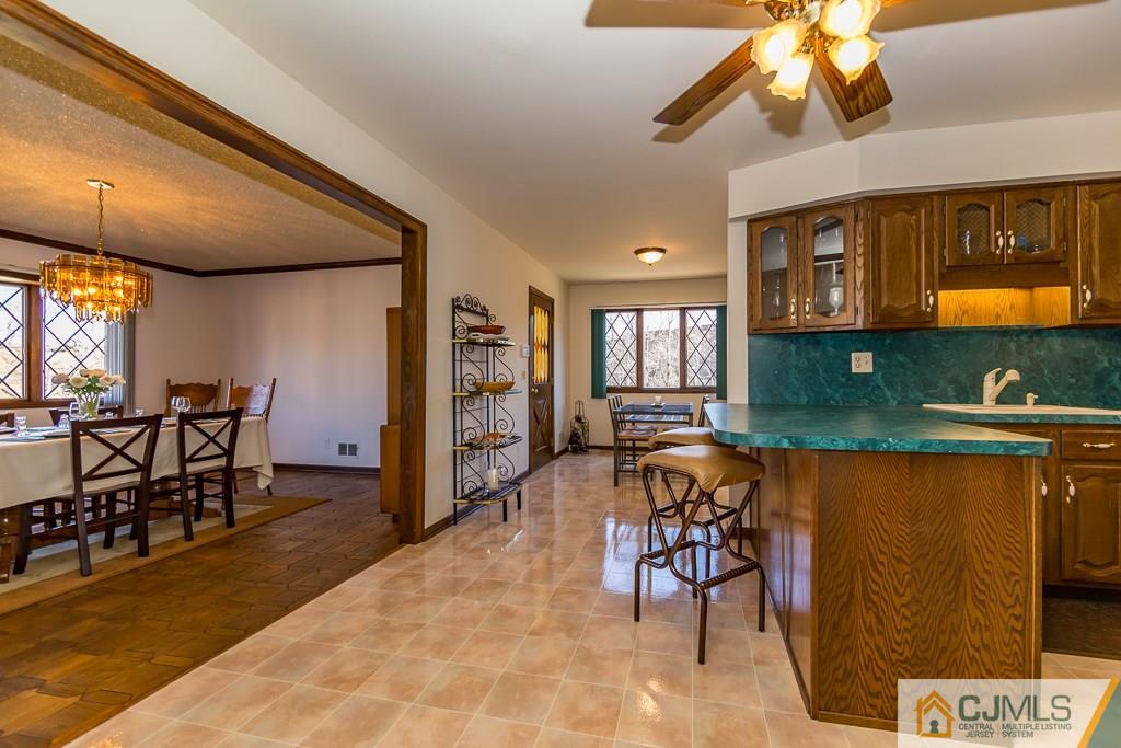 53 Rector Avenue Woodbridge, NJ 07095 - Photo 9 of 25 a view of a dining room with furniture and a chandelier