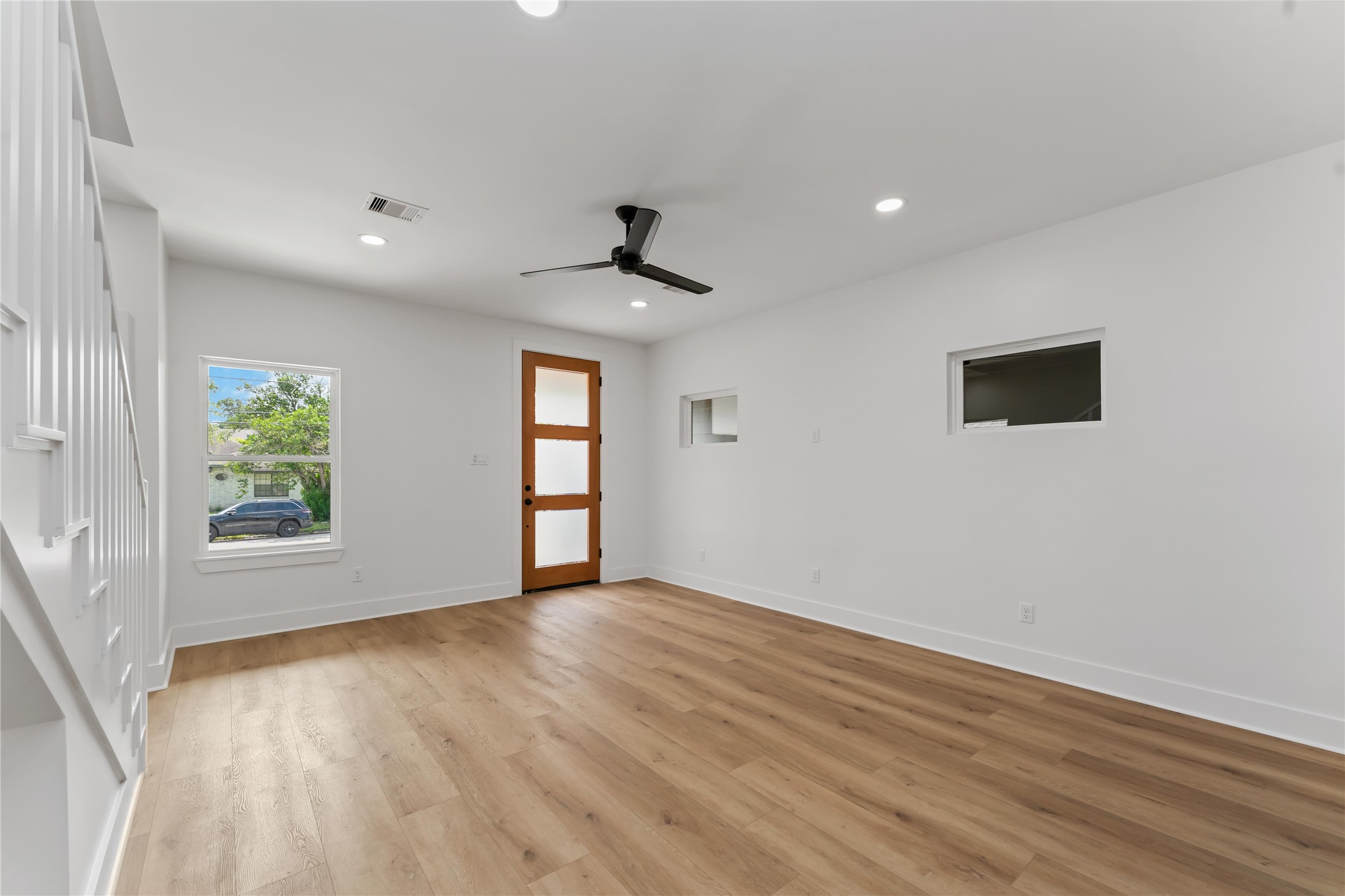 3520 Castor Street, Unit A B Houston, TX 77022 - Photo 13 of 47 a view of an empty room with a window and wooden floor