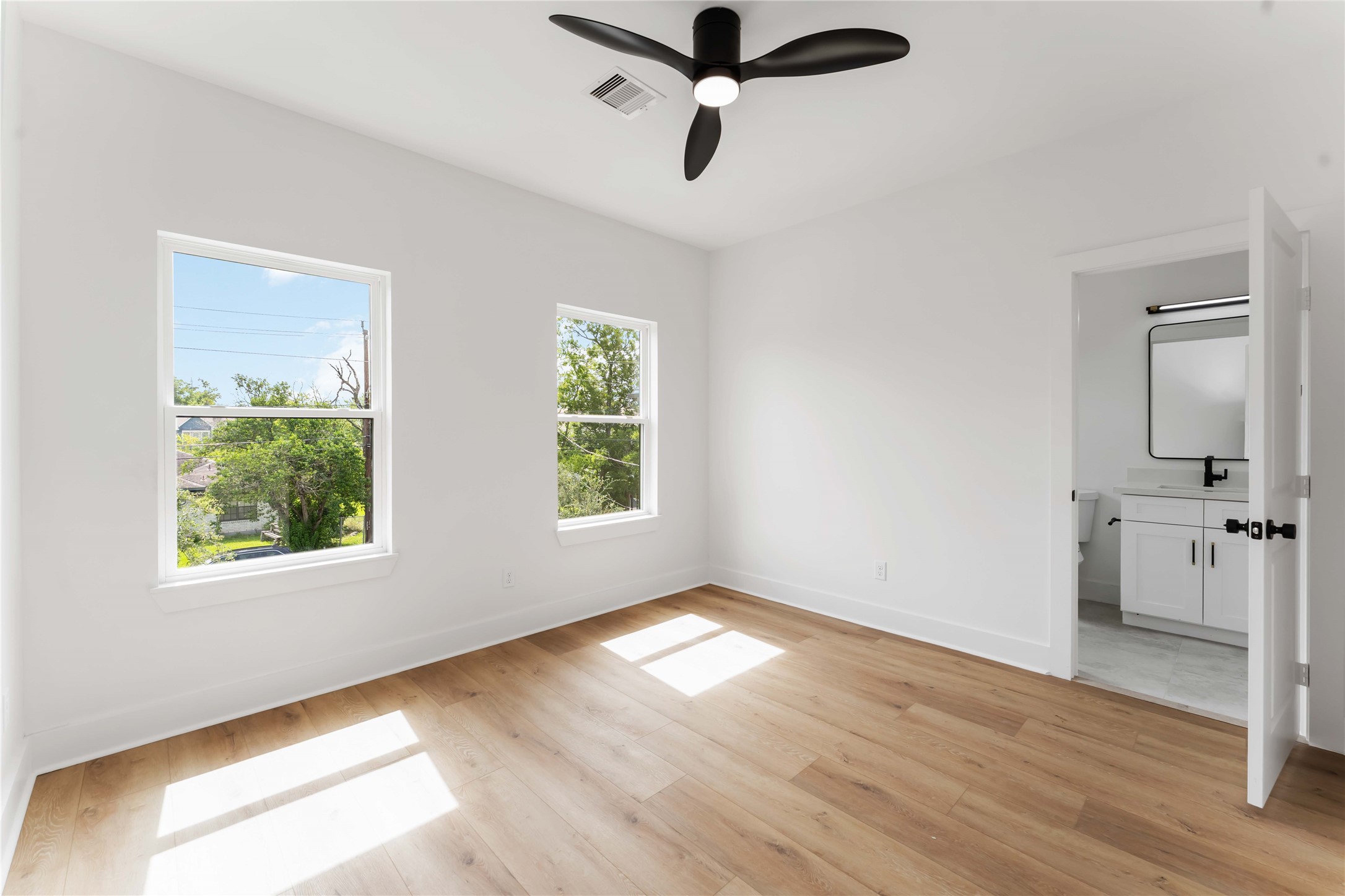3520 Castor Street, Unit A B Houston, TX 77022 - Photo 19 of 47 a view of empty room with wooden floor and fan