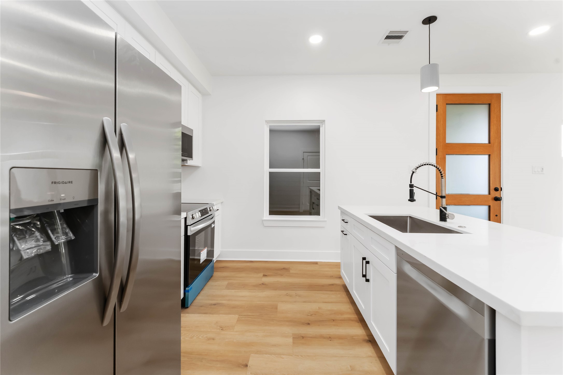 3520 Castor Street, Unit A B Houston, TX 77022 - Photo 28 of 47 a kitchen with stainless steel appliances granite countertop a refrigerator a sink and a stove