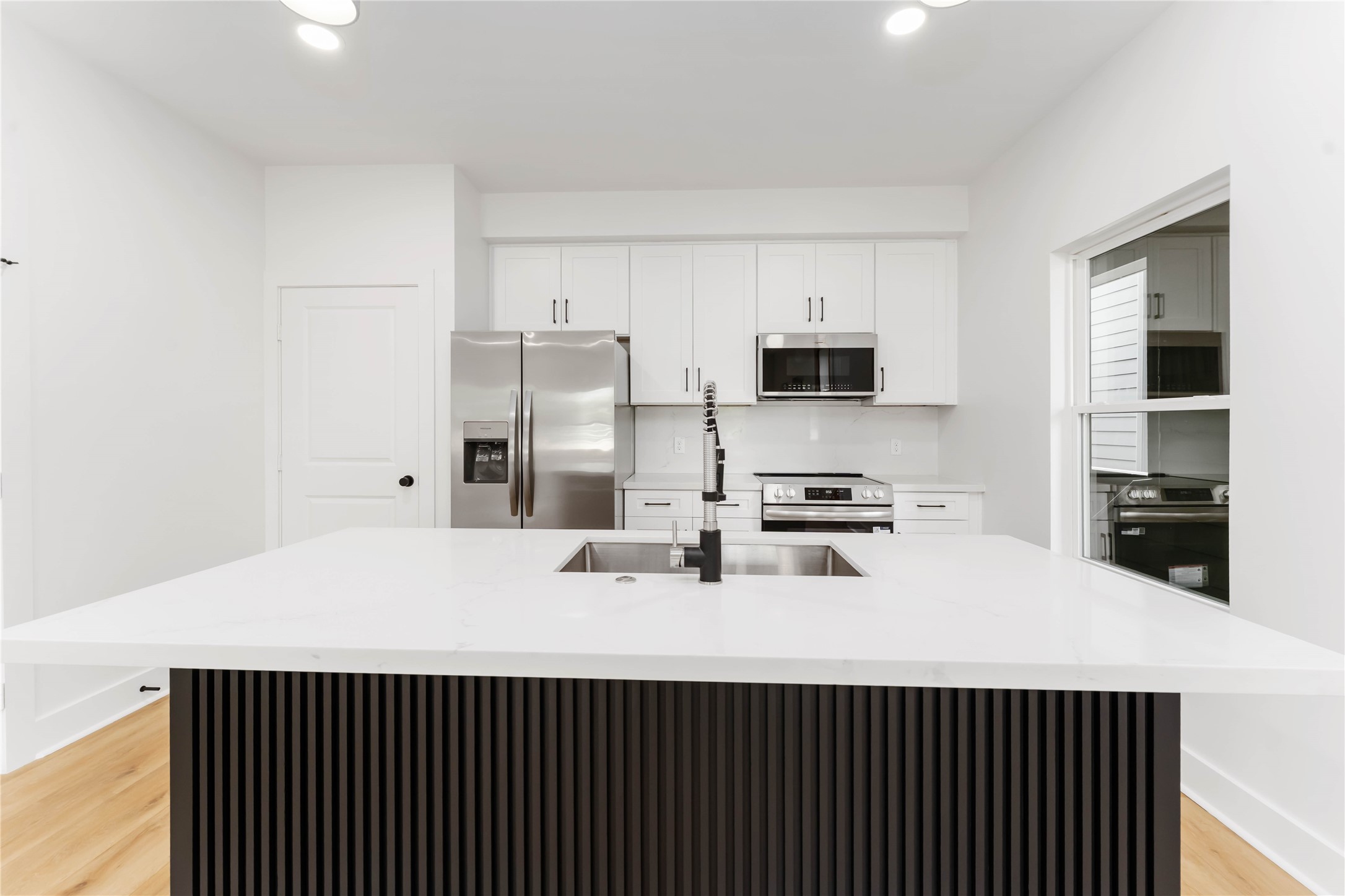 3520 Castor Street, Unit A B Houston, TX 77022 - Photo 30 of 47 a kitchen with a sink a stove and refrigerator
