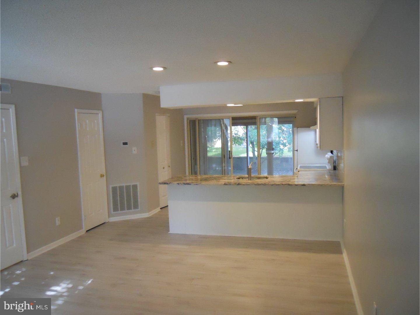 309 Headhouse Court Wayne, PA 19087 - Photo 4 of 16 a view of an empty room with wooden floor and a window