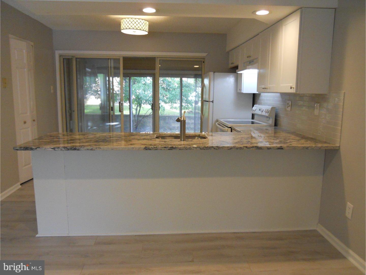 309 Headhouse Court Wayne, PA 19087 - Photo 6 of 16 a view of kitchen with granite countertop cabinets and a sink