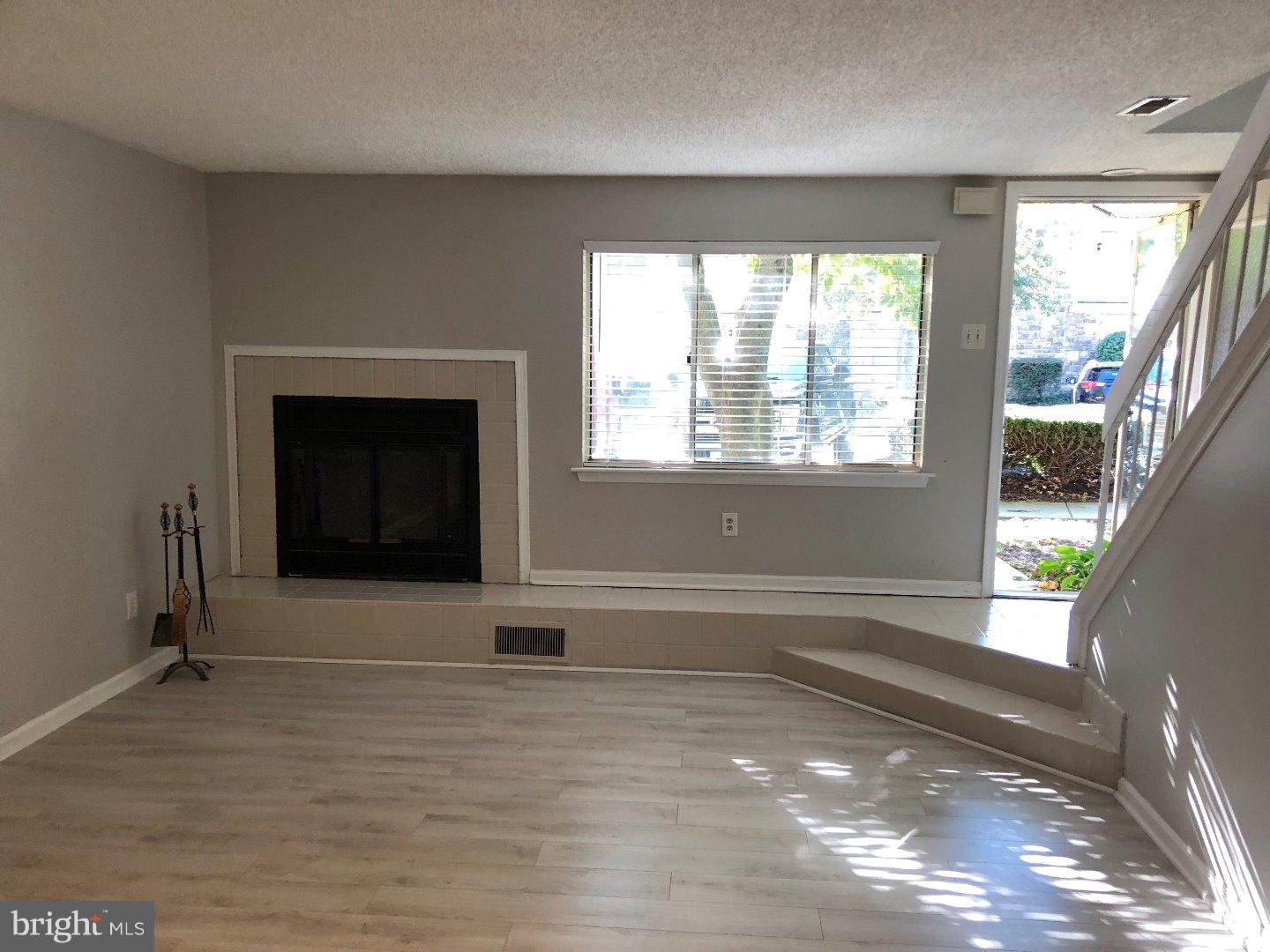 309 Headhouse Court Wayne, PA 19087 - Photo 7 of 16 a view of an empty room with a window and wooden floor