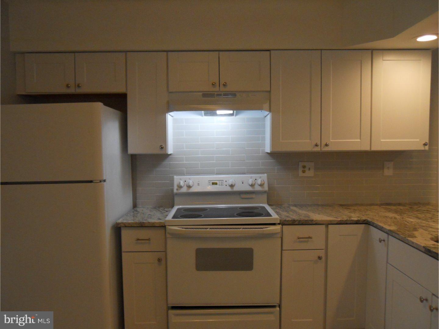 309 Headhouse Court Wayne, PA 19087 - Photo 8 of 16 a kitchen with a stove and a refrigerator