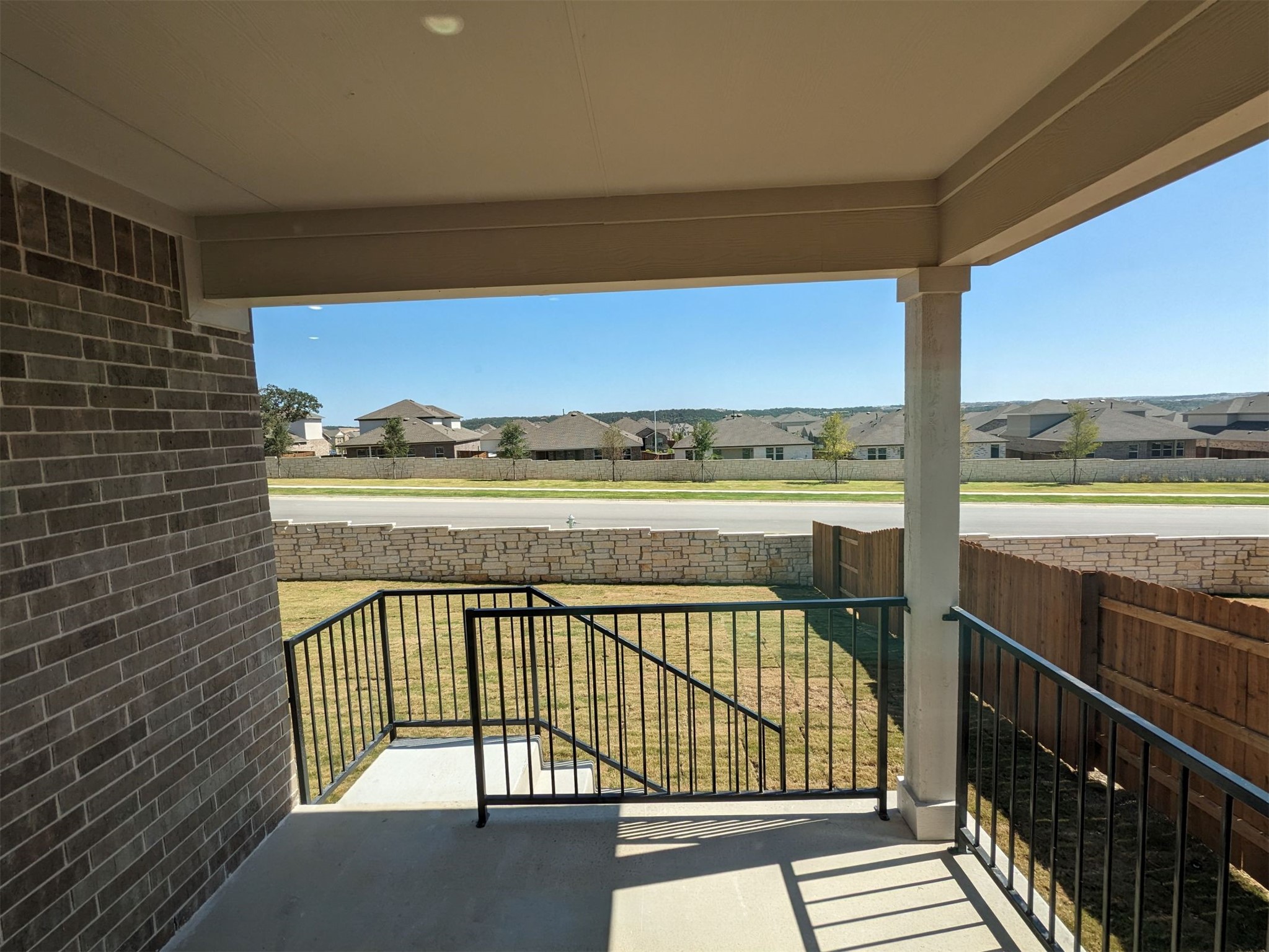 2412 Lightning View Leander, TX 78641 - Photo 24 of 24 Enjoy the outdoor views from this charming covered patio, featuring a durable brick exterior.