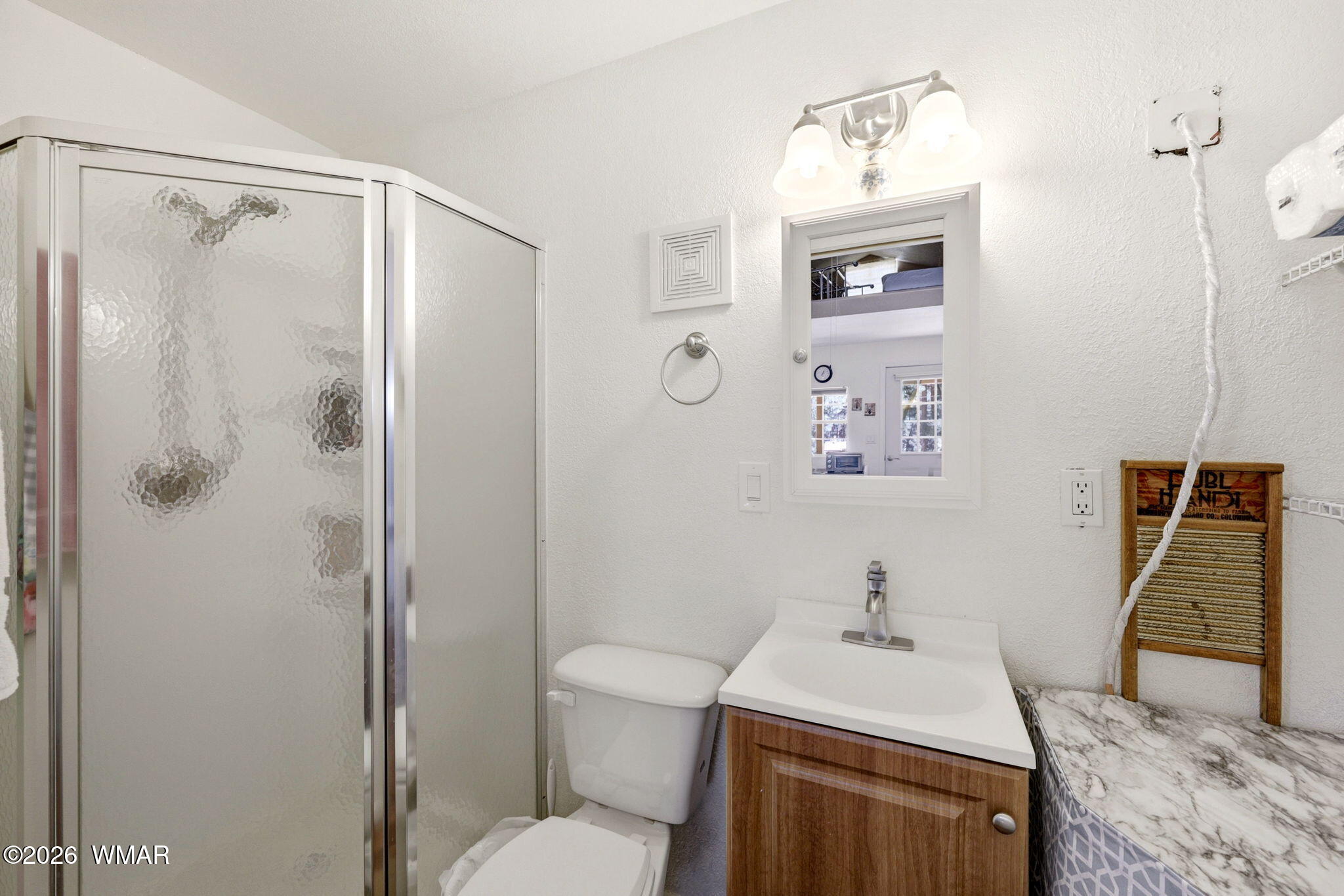 2893 Tracy Road Overgaard, AZ 85933 - Photo 22 of 26 a bathroom with a sink a toilet and shower