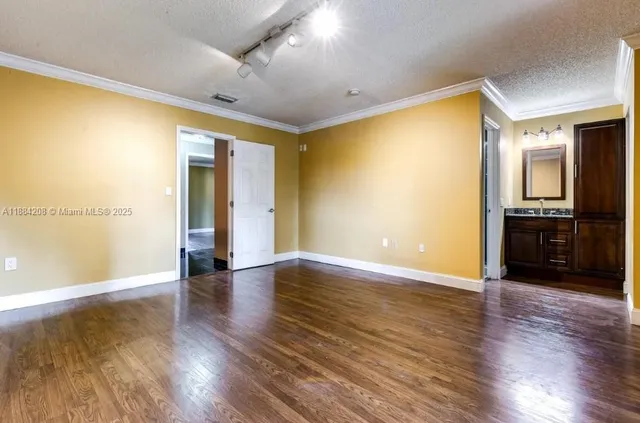 a bathroom with a granite countertop sink toilet and mirror