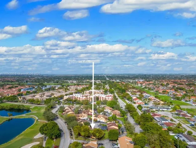 an aerial view of residential building and lake