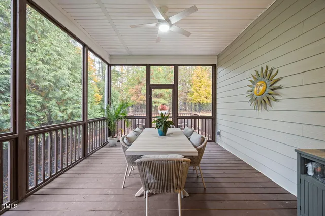 a dining room with furniture a chandelier and wooden floor