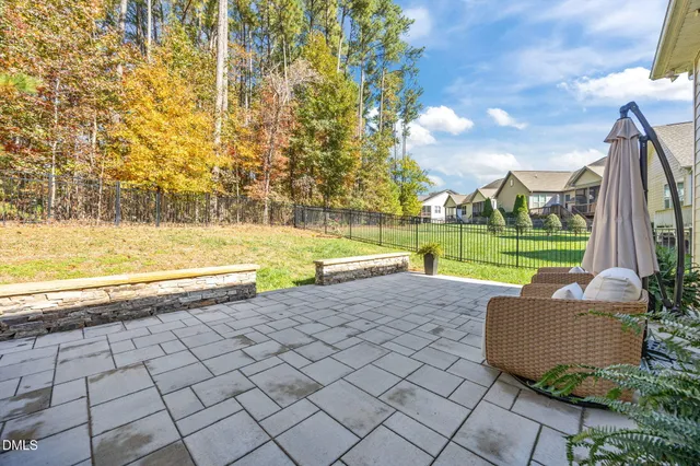 a view of a house with swimming pool and a yard
