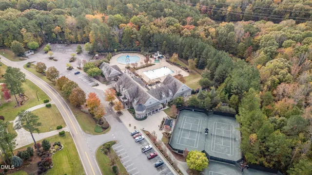 a view of swimming pool with lawn chairs and couches