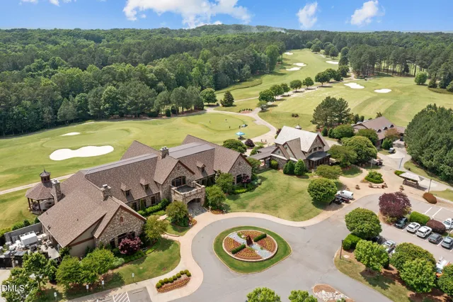 an aerial view of a house with swimming pool and garden