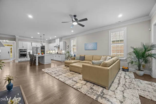 a living room with furniture and kitchen view