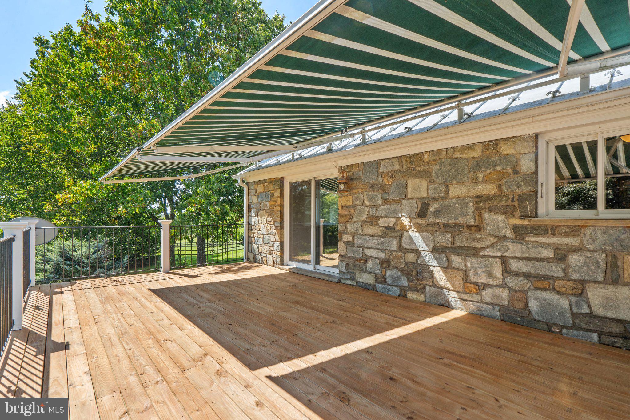8313 Stable Gate Road Warrenton, VA 20186 - Photo 26 of 80 Deck with awning accessible from Dining Room and