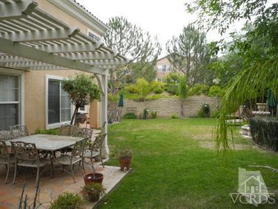 291 Culview Court Simi Valley, CA 93065 - Photo 7 of 9 a view of a patio with table and chairs potted plants and large tree