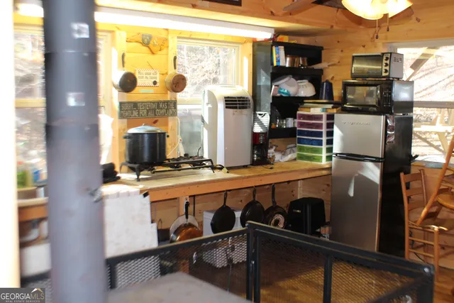 a kitchen with a large window appliances and cabinets