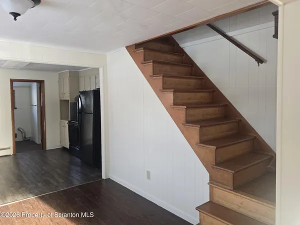 a view of entryway with wooden floor and stairs