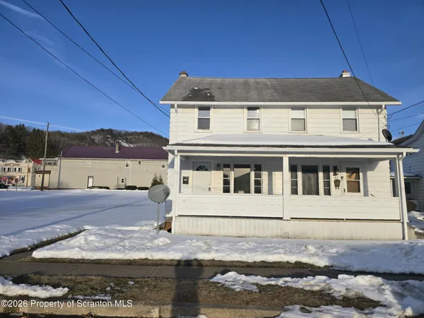 a view of a white house with large windows