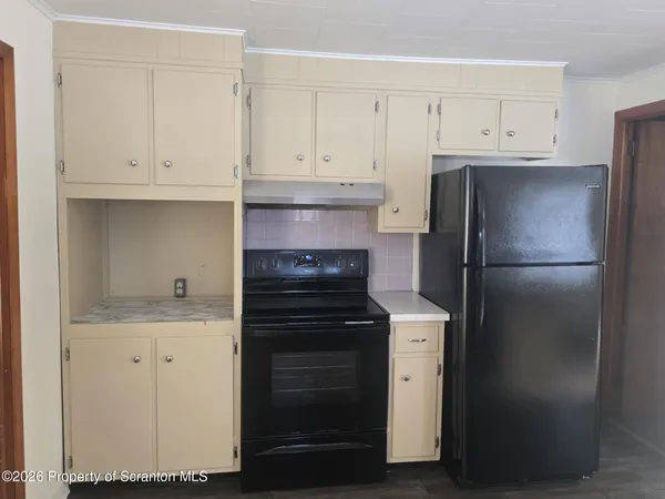 a kitchen with cabinets and stainless steel appliances