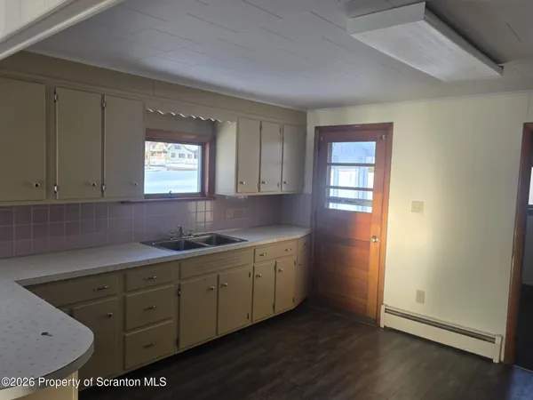 a kitchen with sink and cabinets