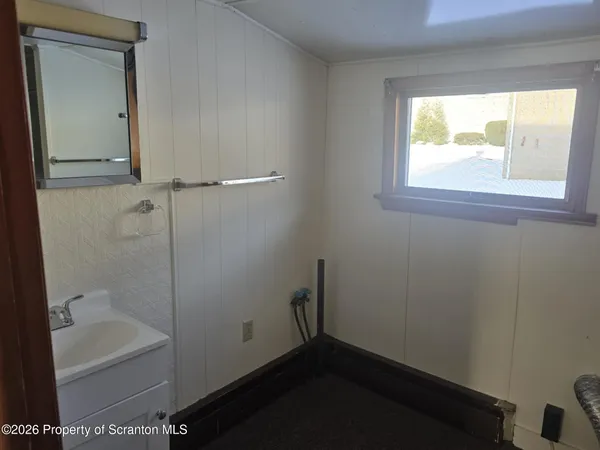 a bathroom with a bathtub and a window