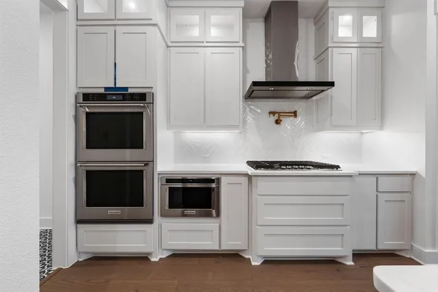 a kitchen with kitchen island a sink stainless steel appliances and cabinets