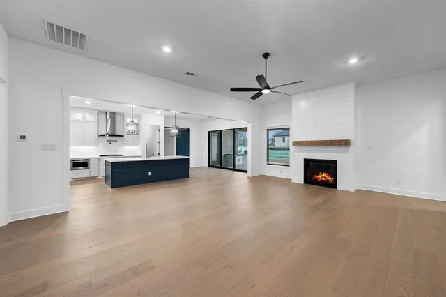 a view of an empty room with floor to ceiling window and an entryway