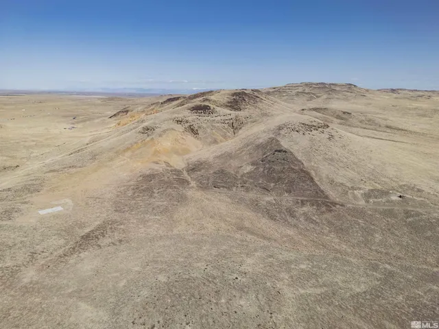 a view of mountain with sunset in background